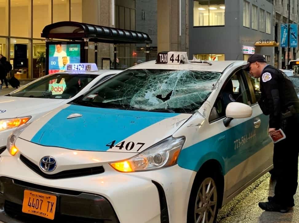 Strong winds knock sign off scaffolding at the Willis Tower, damaging a taxi and another vehicle